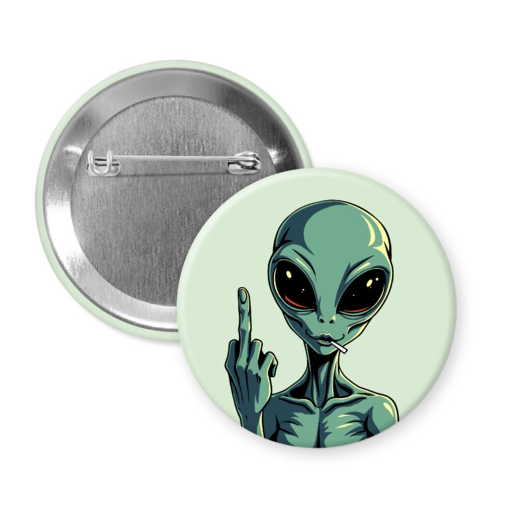 Pin button with an alien design showing a middle finger on a light green background