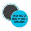 Blue magnet that says "I'm so tired of being my wife's arm candy."