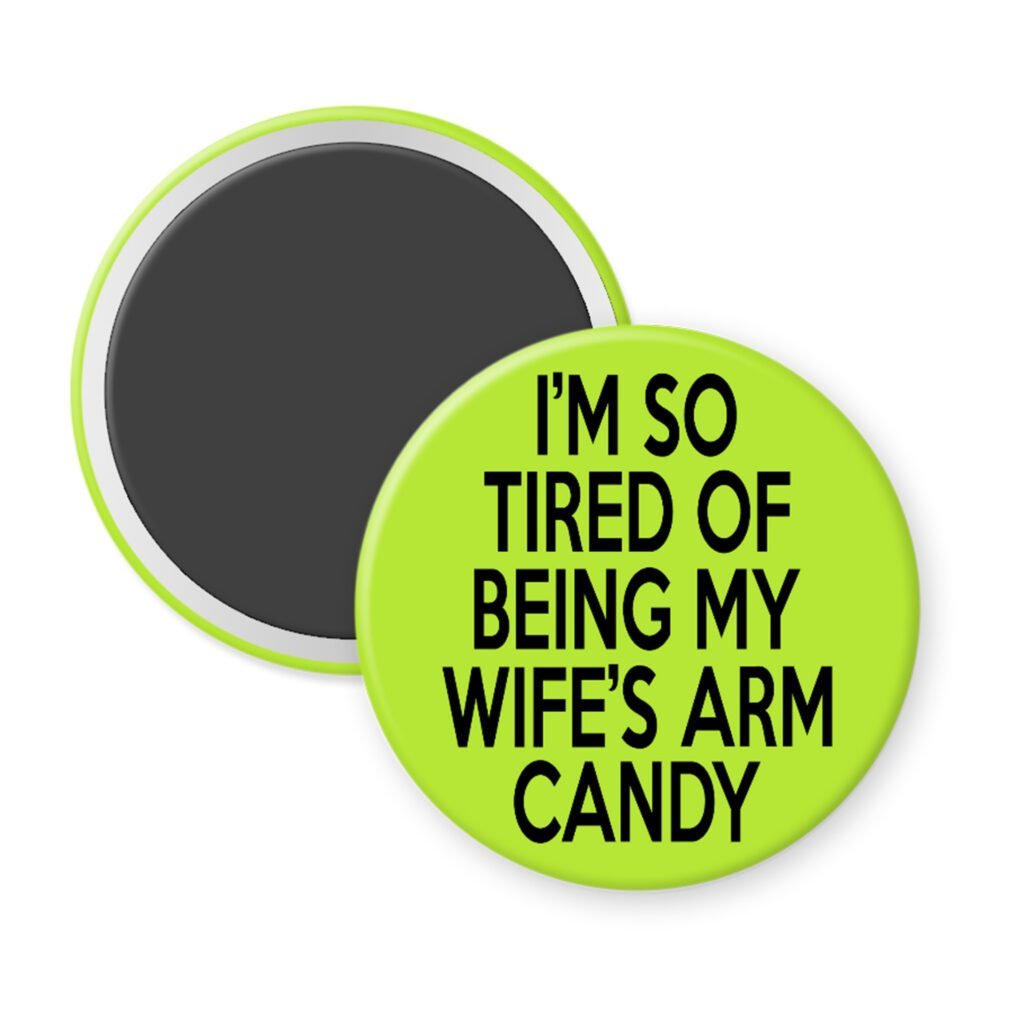 Green magnet with text 'I'm so tired of being my wife's arm candy' printed in black.