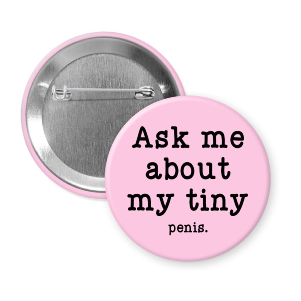 Pink pinback button with text 'Ask me about my tiny penis' printed in black.