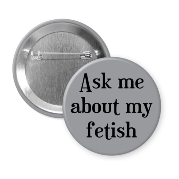 Grey pinback button with the text 'Ask me about my fetish' printed in black.