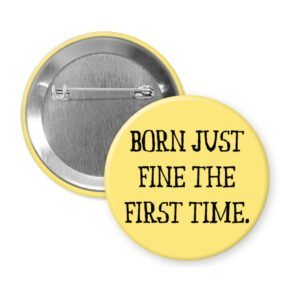 Yellow pinback button with the text 'Born just fine the first time.' printed in black.