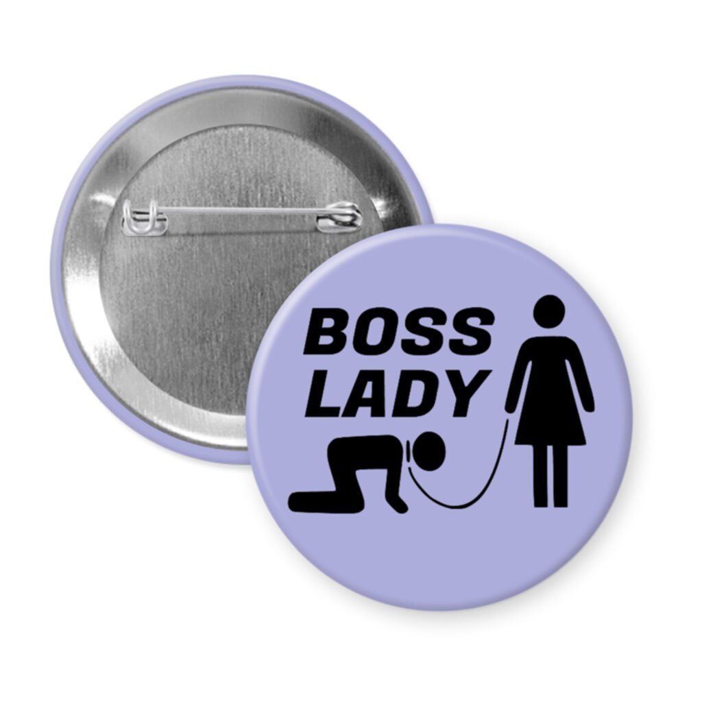 Purple pinback button with a graphic of a collared and leashed man on hands and knees, a woman figure holding the leash with the text 'BOSS LADY' printed in black.