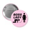 Light pink pinback buttonwith a graphic of a collared and leashed man on hands and knees, a woman figure holding the leash with the text 'BOSS LADY' printed in black.
