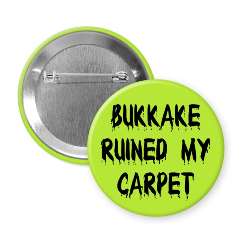 Green pinback button with the text 'Bukkake ruined my carpet' in black drippy font.