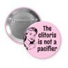 Pink pin button with vintage woman graphic and the words "The clitoris is not a pacifier"