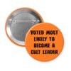 Orange pinback button with the text 'Voted most likely to become a cult leader' printed in black.