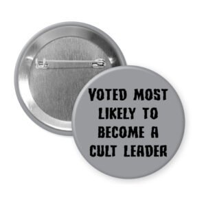 Grey pinback button with the text 'Voted most likely to become a cult leader' printed in black.