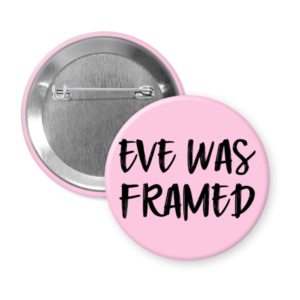 Pink pinback button with the text 'Eve was framed' printed in black.
