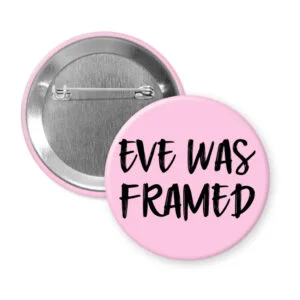 Pink pinback button with the text 'Eve was framed' printed in black.