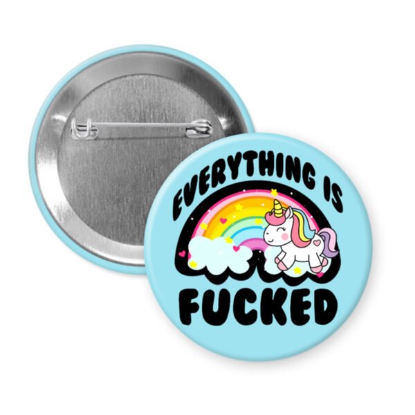 Pin button with unicorn and rainbow design on a light blue background