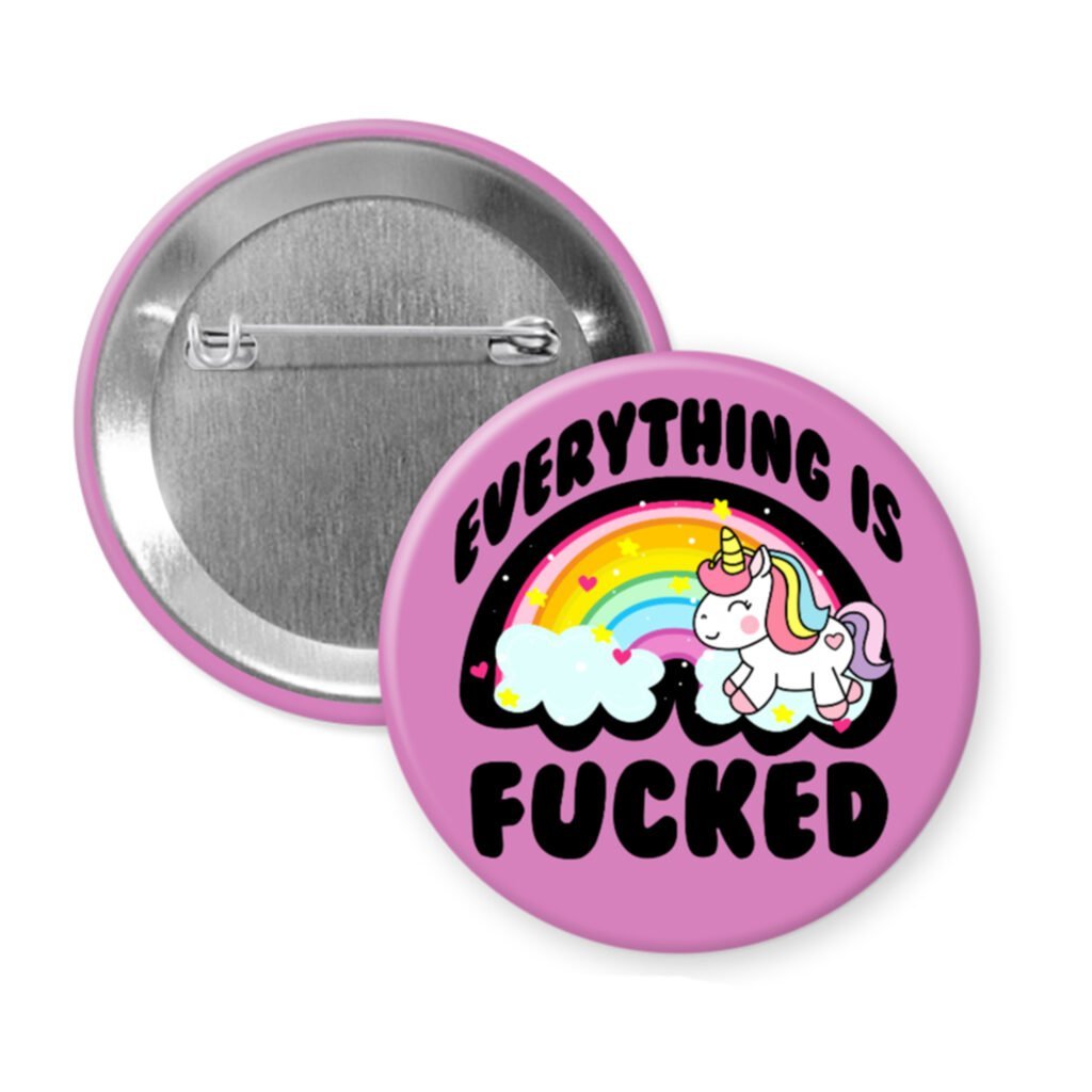 Pin button with unicorn and rainbow design on a light blue background