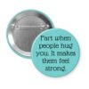Blue pinback button with the text 'Fart when people hug you. It makes them feel strong.' printed in black.