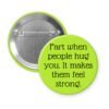 Lime green pinback button with the text 'Fart when people hug you. It makes them feel strong.' printed in black.
