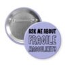 Purple pinback button with the text 'Ask me about fragile masculinity' printed in black.