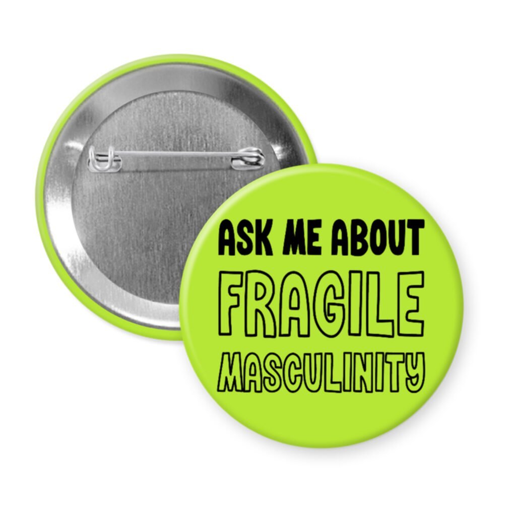 Green pinback button with the text 'Ask me about fragile masculinity' printed in black.