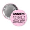 Pink pinback button with the text 'Ask me about fragile masculinity' printed in black.