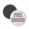 Round magnet with floral design and 'FREE SHRUGS' text on a white background.