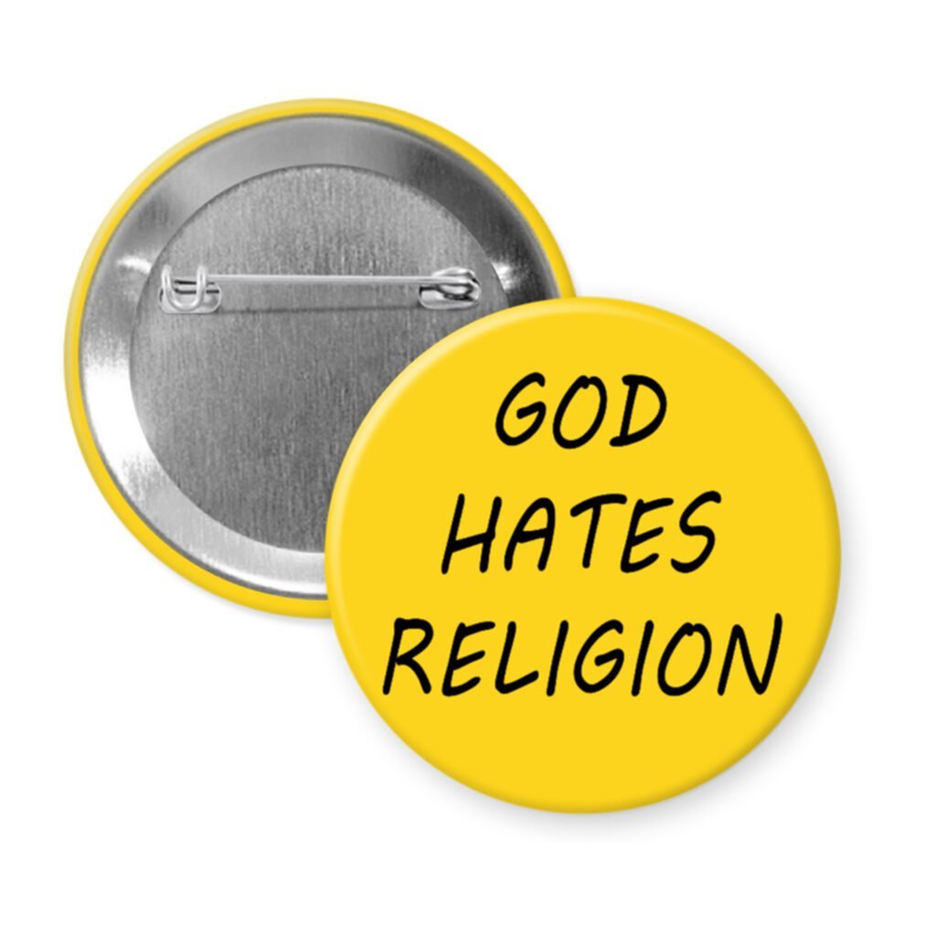 Yellow pinback button with the text 'God hates religion' printed in black.
