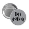 Grey pinback button with the text 'I'm a grown-up' printed in black.