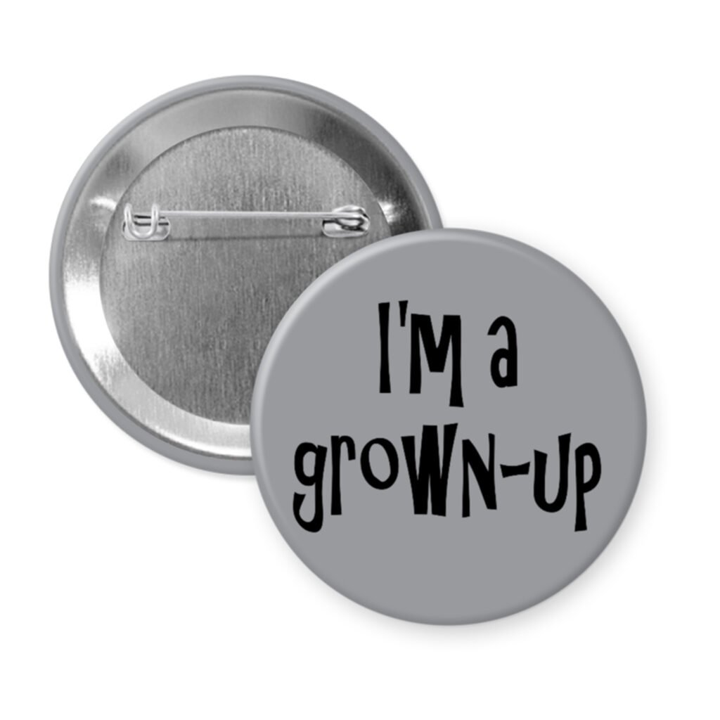Grey pinback button with the text 'I'm a grown-up' printed in black.