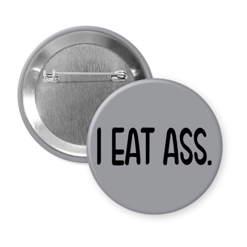 Grey pinback button with the text 'I eat ass.' printed in black.