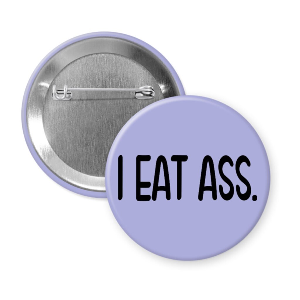 Purple pinback button with the text 'I eat ass.' printed in black.