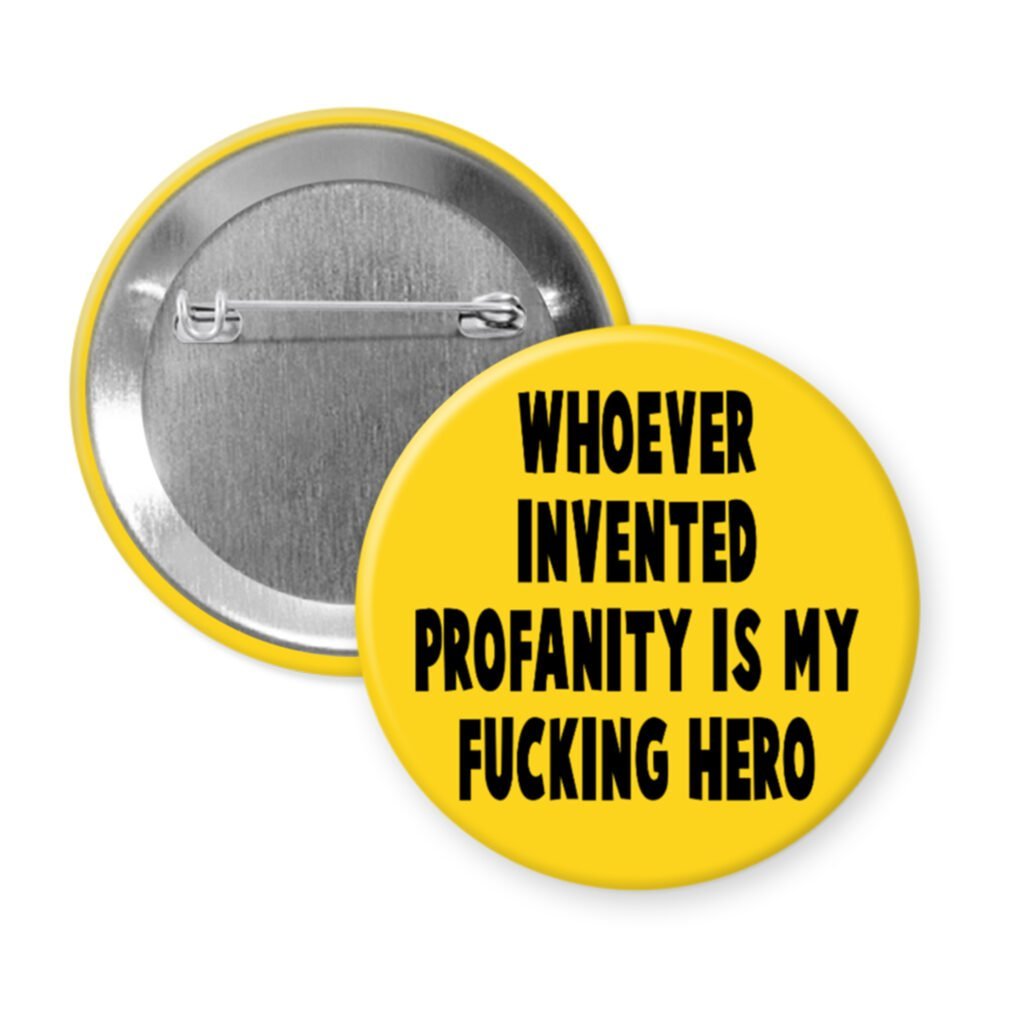 Yellow pinback button with the text 'Whoever invented profanity is my fucking hero.' printed in black.