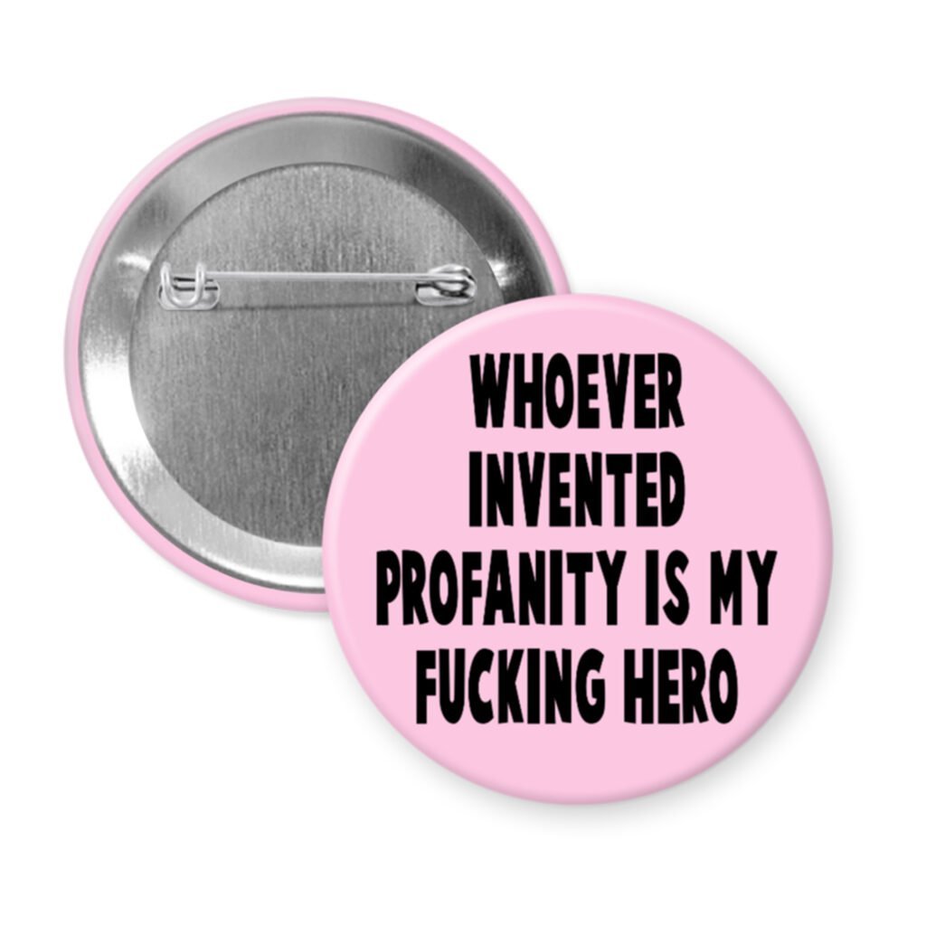 Pink pinback button with the text 'Whoever invented profanity is my fucking hero.' printed in black.