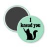Green magnet with silhouette of a cat and the text 'I knead you.'