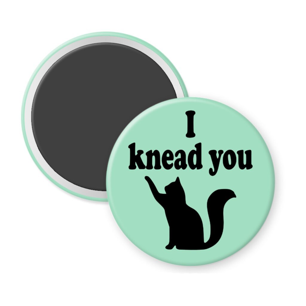 Green magnet with silhouette of a cat and the text 'I knead you.'