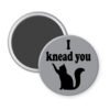 Grey magnet with silhouette of a cat and the text 'I knead you.'