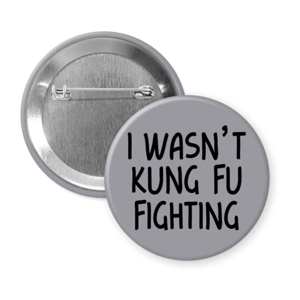 Grey pinback button with the text 'I wasn't kung fu fighting' printed in black.