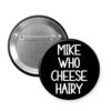 Black button that says 'Mike Who Cheese Hairy'.