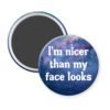 Galaxy print magnet with the text 'I'm nicer than my face looks' printed in white.