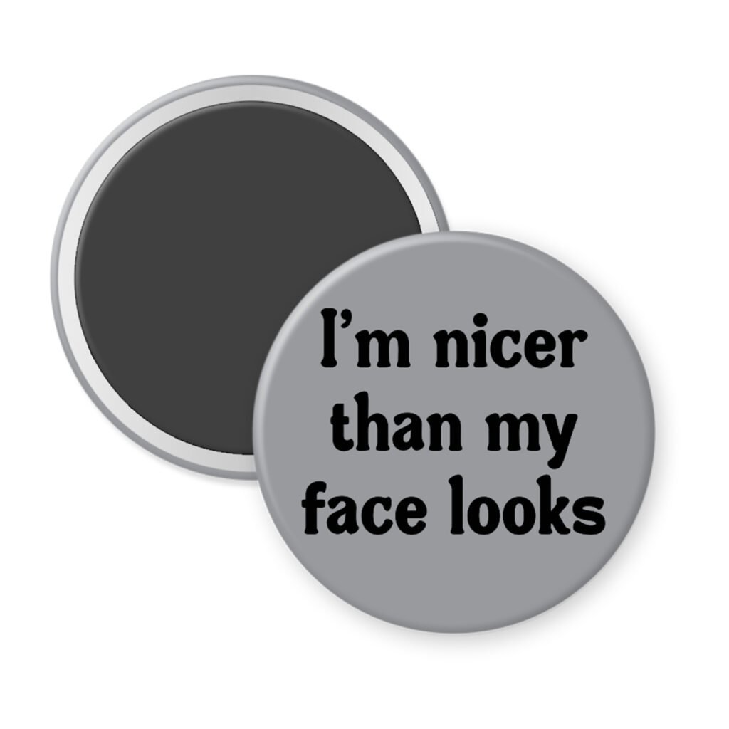 Grey magnet with the text 'I'm nicer than my face looks' printed in black.