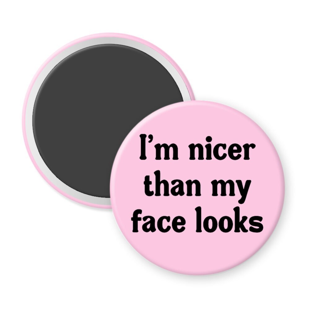 Pink magnet with the text 'I'm nicer than my face looks' printed in black.