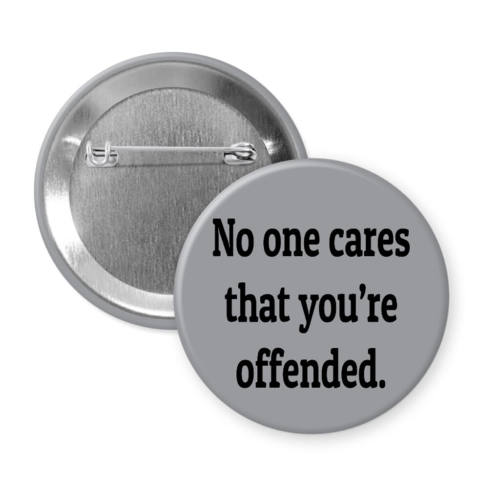 Grey pinback button with the text 'No one cares that you're offended.' printed in black.
