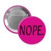 Pink pinback button with the text 'NOPE.' printed in black.