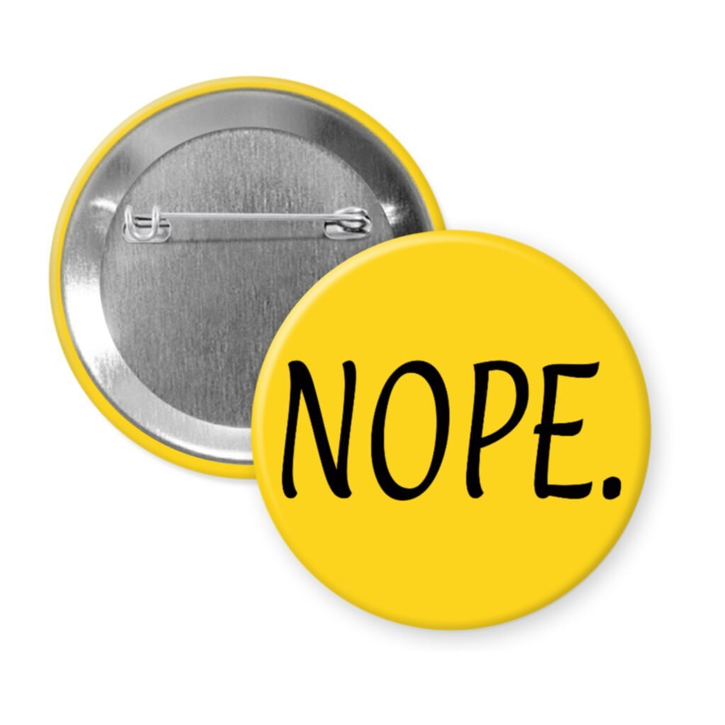 Yellow pinback button with the text 'NOPE.' printed in black.