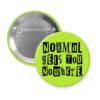 Green pinback button with the text "Normal gets you nowhere" printed in black stencil graffiti font.