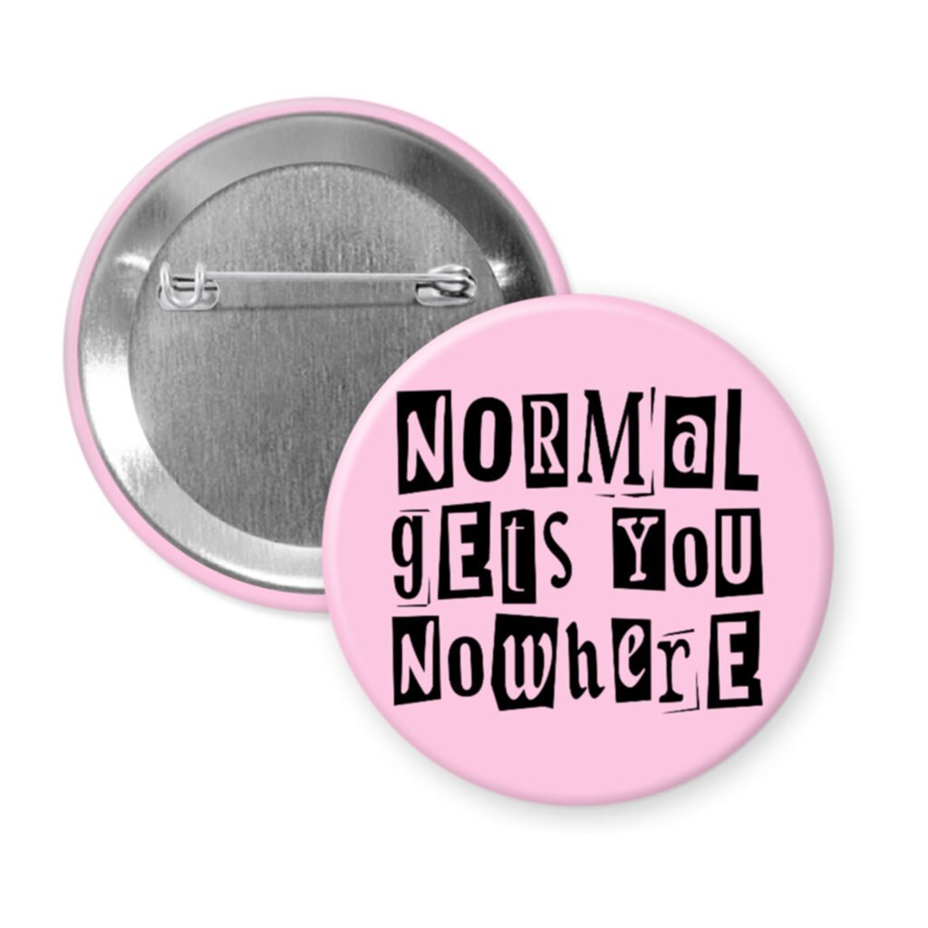 Pink pinback button with the text "Normal gets you nowhere" printed in black stencil graffiti font.