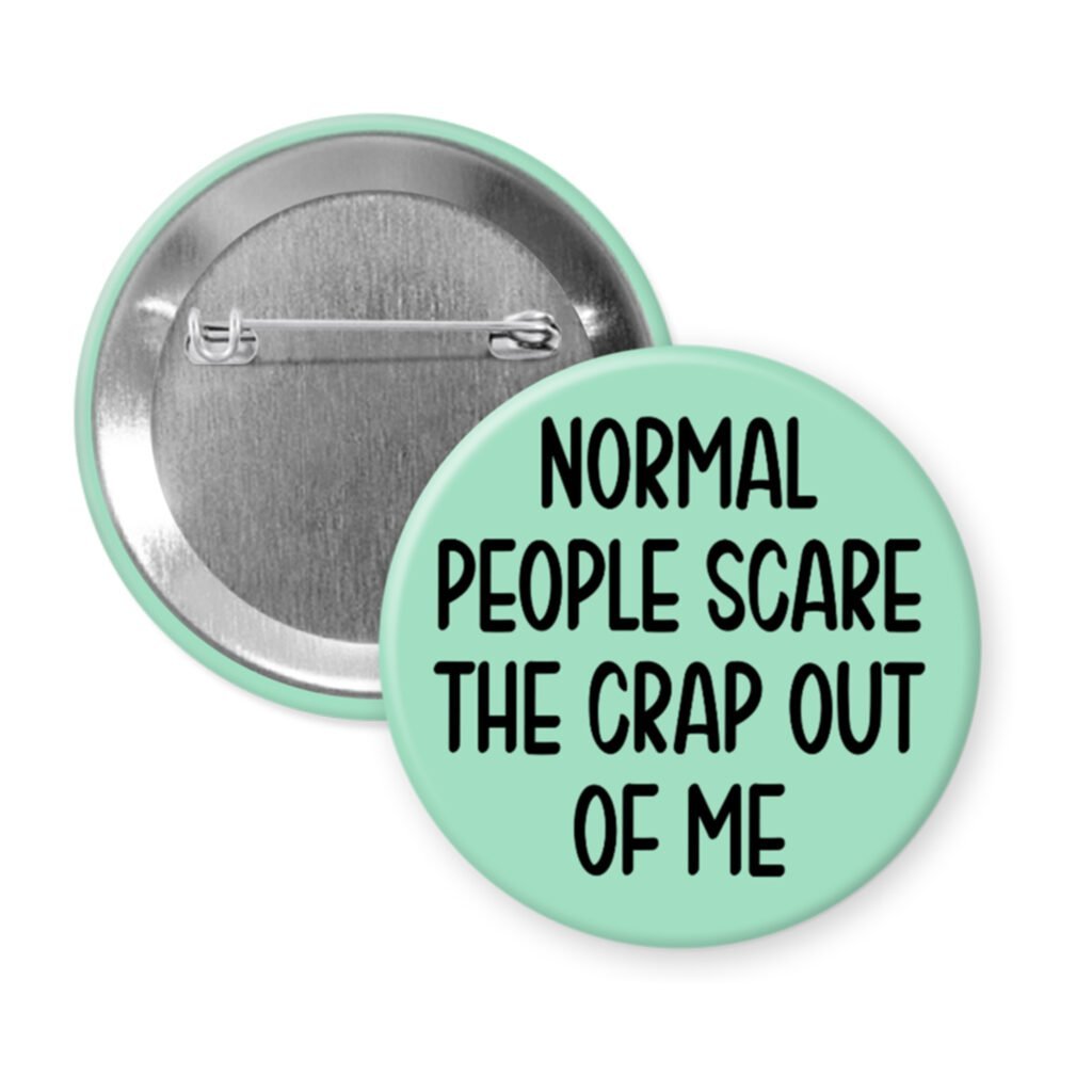 Mint green pinback button with the text 'Normal people scare the crap out of me' printed in black.