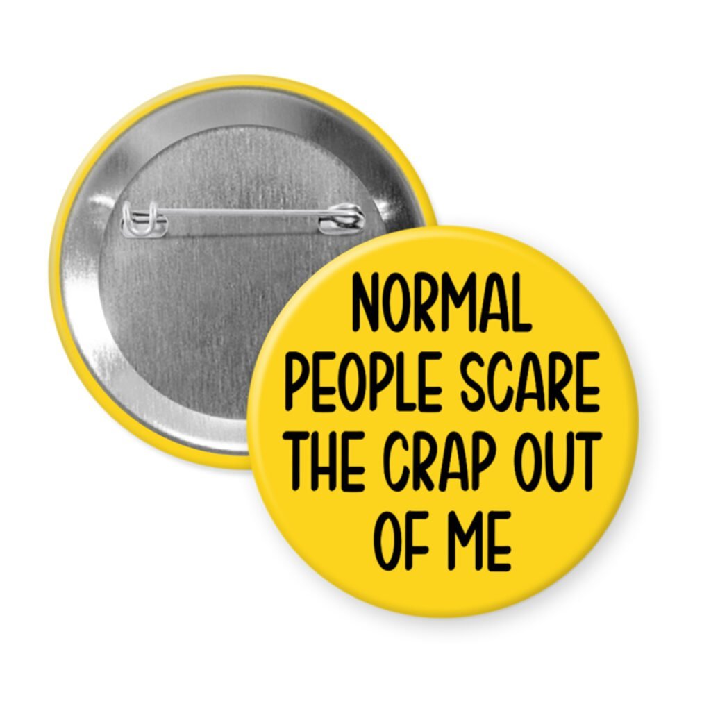 Yellow pinback button with the text 'Normal people scare the crap out of me' printed in black.