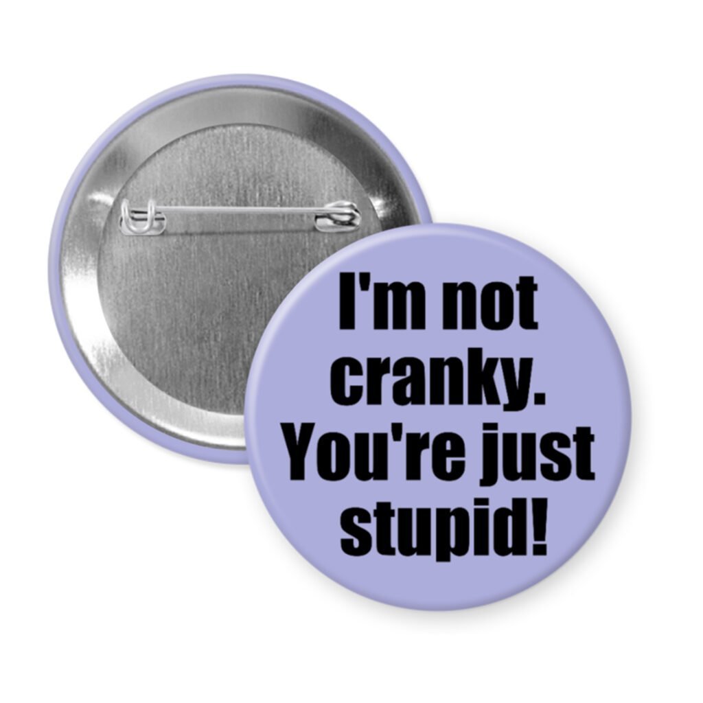 Purple pinback button with the text 'I'm not cranky. You're just stupid!' printed in black.
