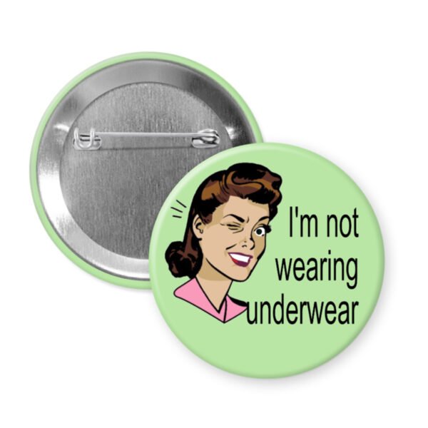 Button badge with a cartoon illustration of a woman and text 'I'm not wearing underwear' on a light green background.