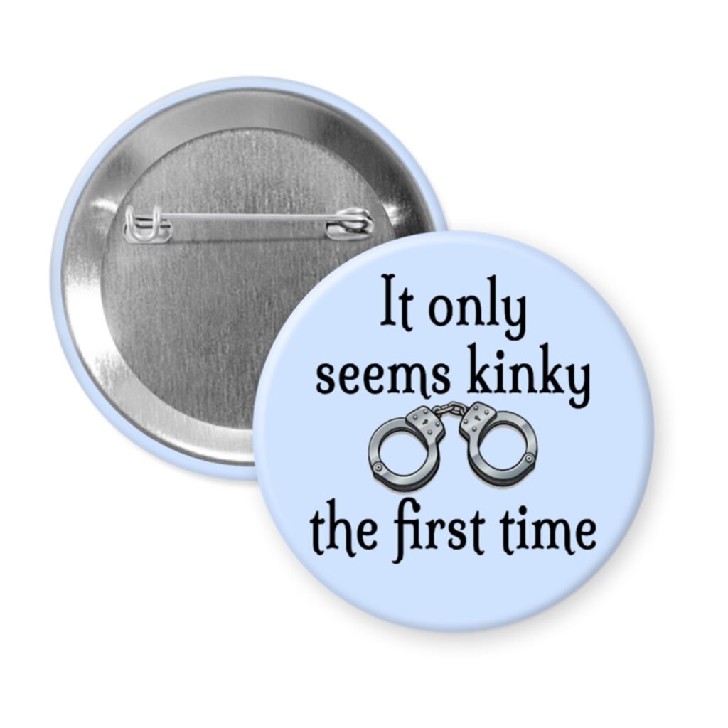 Blue pinback button with the text 'It only seems kinky the first time' and an image of handcuffs.