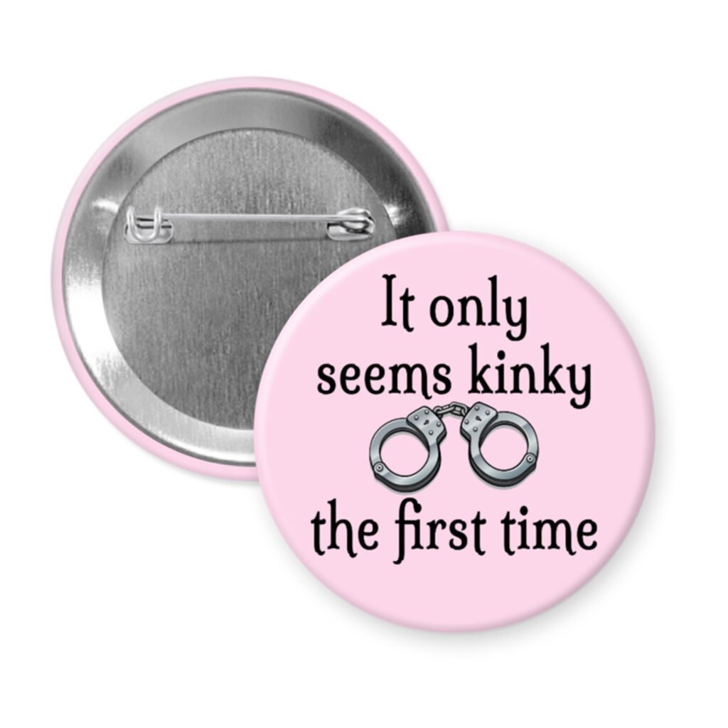Pink pinback button with the text 'It only seems kinky the first time' and an image of handcuffs.