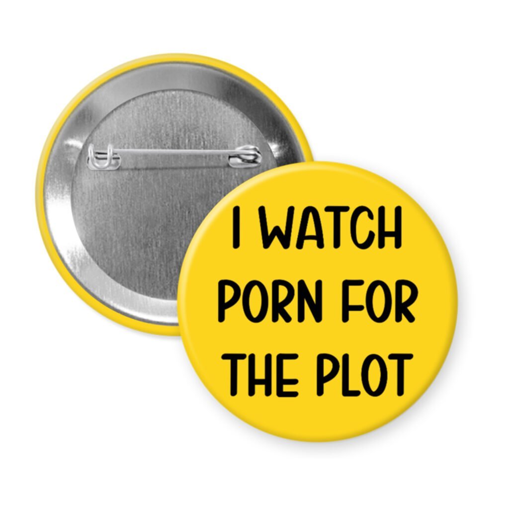 Yellow pinback button with the text 'I watch porn for the plot' printed in black.