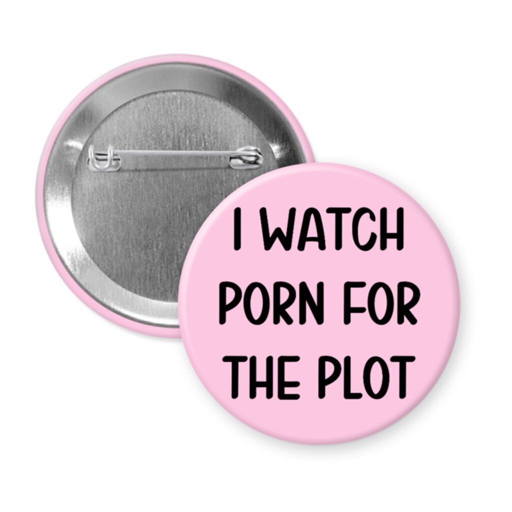 Pink pinback button with the text 'I watch porn for the plot' printed in black.